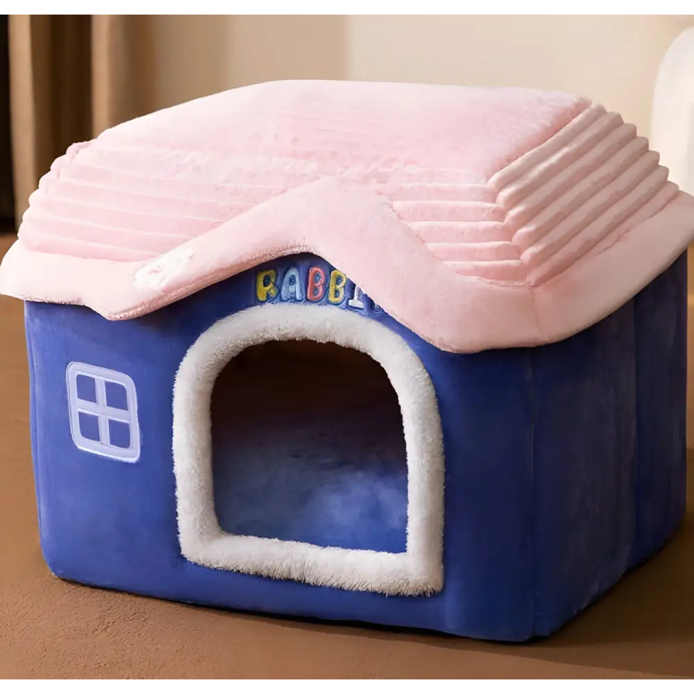 Plush pet house with a blue base and pink roof.