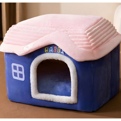 Plush pet house with a blue base and pink roof.