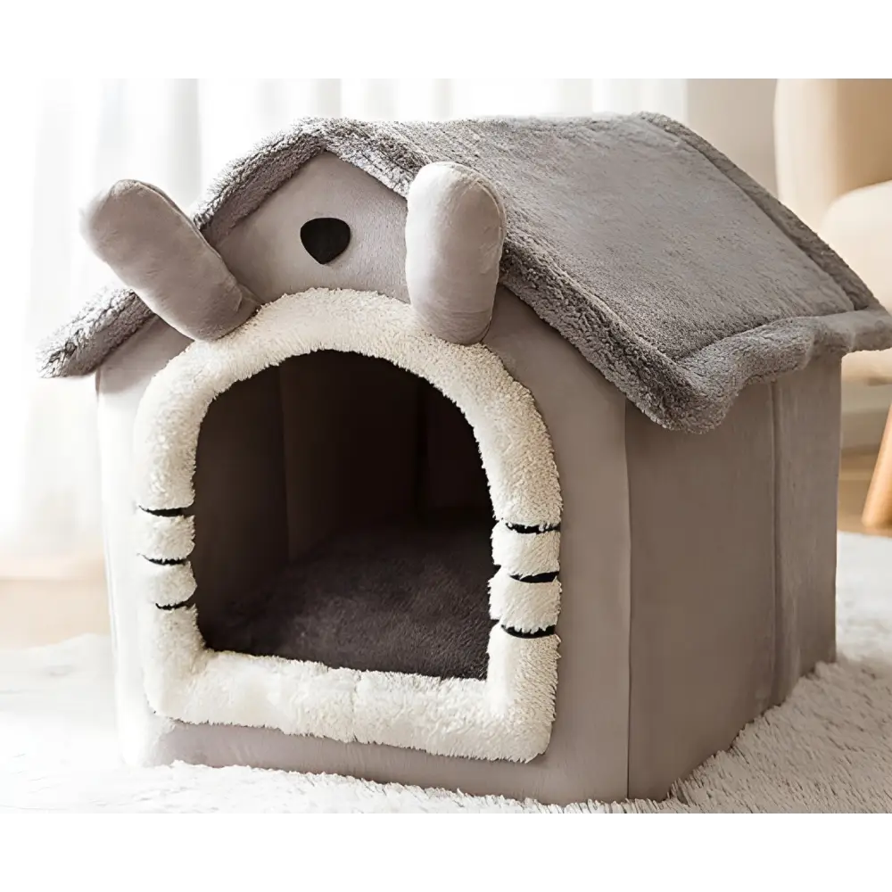 Plush pet house shaped like a bunny with floppy ears and a cozy entrance.