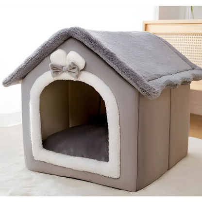 Cozy gray and white pet house with a bow decoration on top.