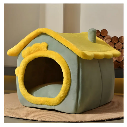 Mint green pet house with yellow trim and a sloped roof.