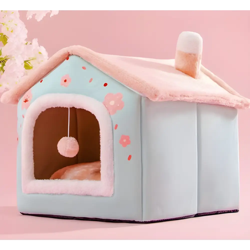 Pastel blue and pink pet house with floral decorations and a plush interior.