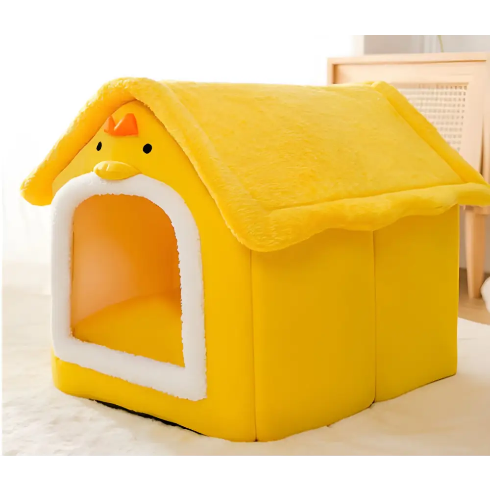 Yellow plush pet house with a white doorway and peaked roof.