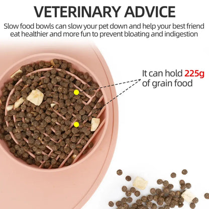 Pink slow feeder bowl with maze-like ridges containing dry pet food.