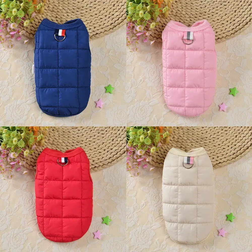 Quilted pet vests in navy blue, pink, red, and beige colors.