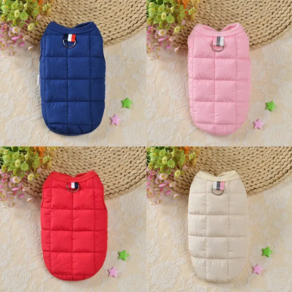 Quilted pet vests in navy blue, pink, red, and beige colors.