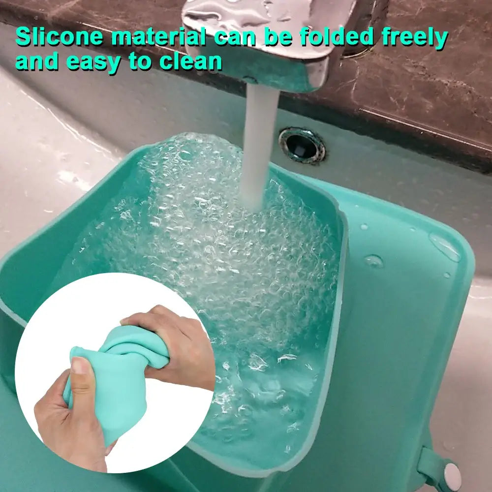 Turquoise silicone sink mat being rinsed with running water.