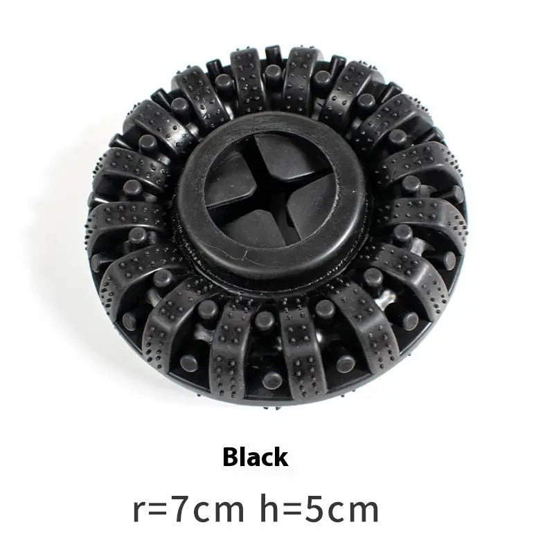 Black circular brush head with radiating rubber bristles and a cross-shaped center.